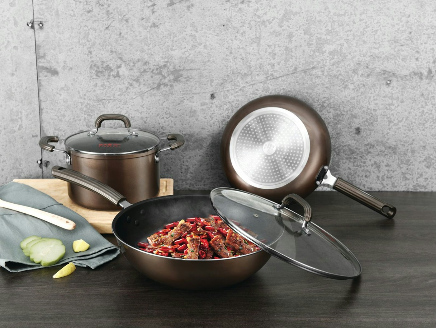 Stainless steel cookware arranged on a wooden table