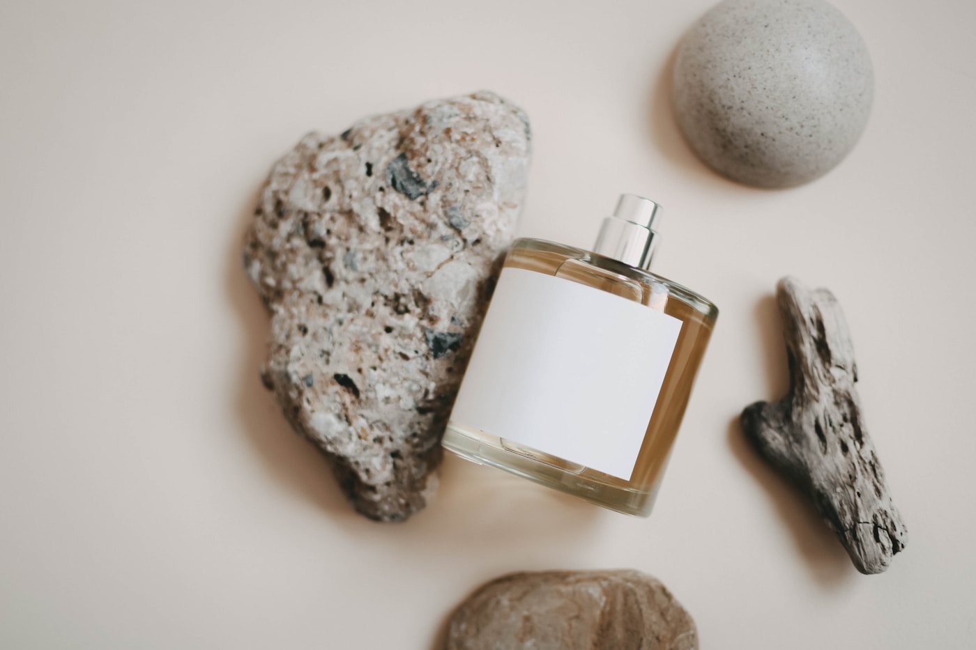 A fragrance bottle staged with rocks for a product photograph